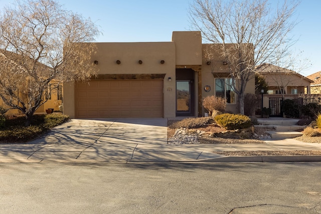 pueblo-style house with a garage