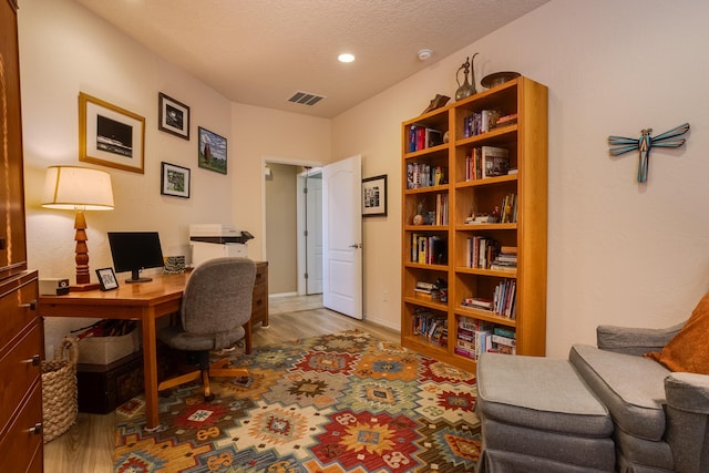 office area featuring hardwood / wood-style floors and a textured ceiling