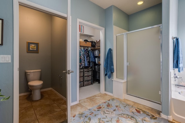 bathroom featuring toilet, tile patterned floors, and independent shower and bath