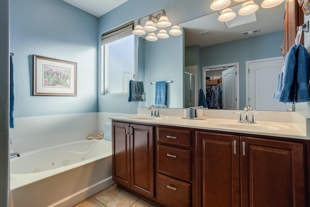 bathroom with vanity, tile patterned flooring, plus walk in shower, and a textured ceiling