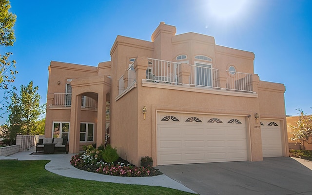 view of front of property with a garage and a balcony