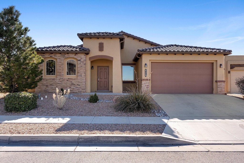 mediterranean / spanish house featuring a garage