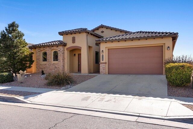 mediterranean / spanish-style house with a garage