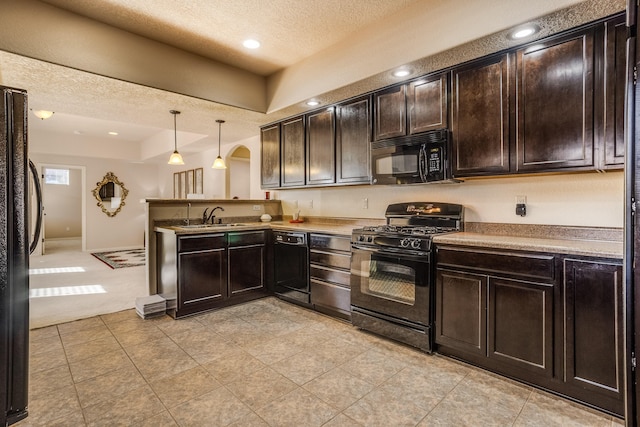 kitchen featuring decorative light fixtures, sink, black appliances, and dark brown cabinets