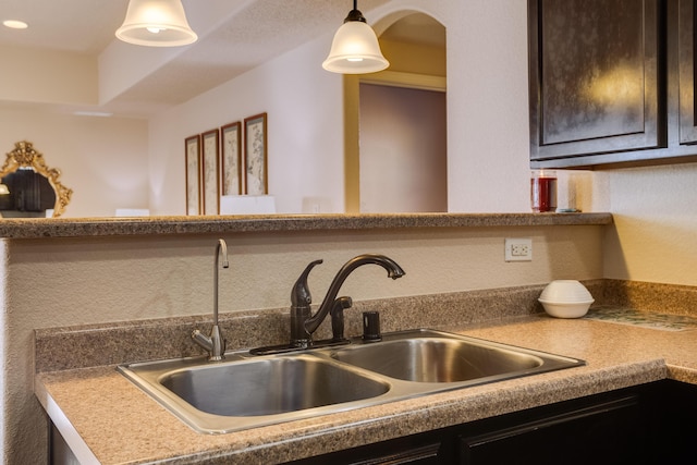 kitchen featuring dark brown cabinets and sink