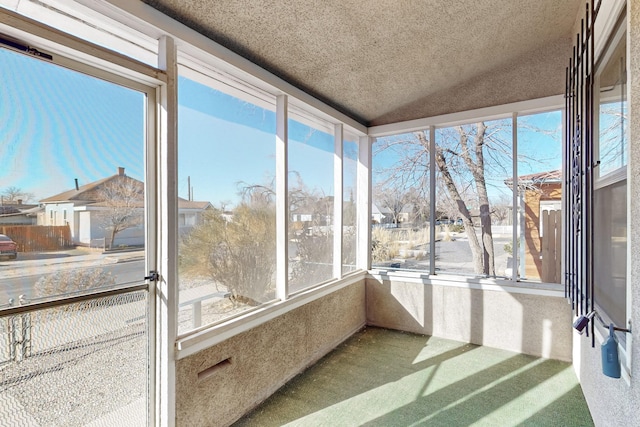 sunroom / solarium featuring vaulted ceiling