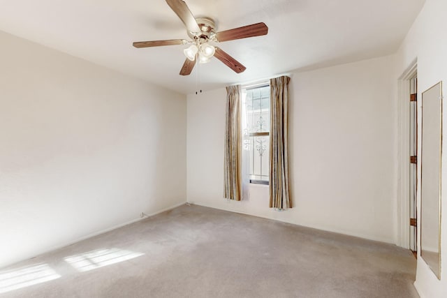 unfurnished room with ceiling fan and light colored carpet