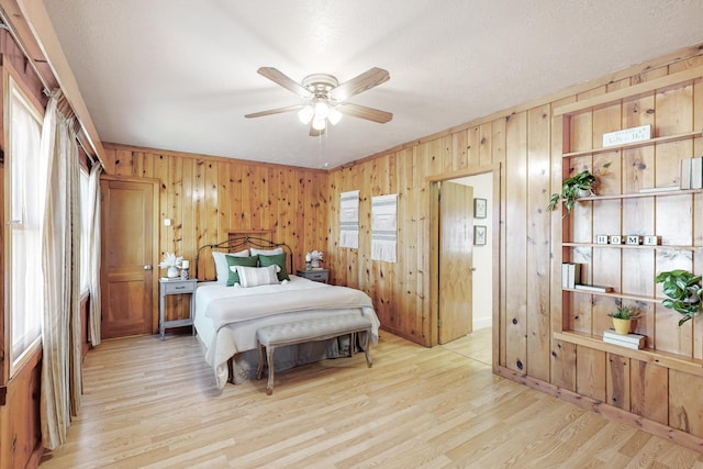 bedroom with ceiling fan and light hardwood / wood-style flooring