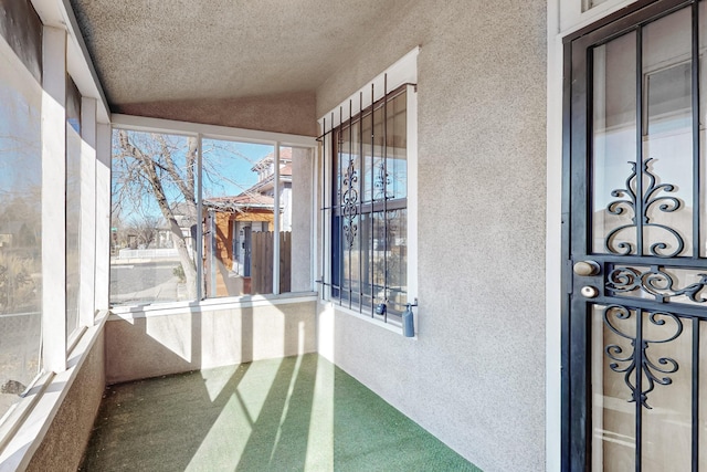 unfurnished sunroom featuring lofted ceiling