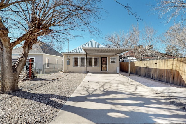 back of house featuring a carport