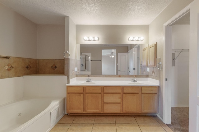 bathroom featuring a textured ceiling, tile patterned flooring, and vanity