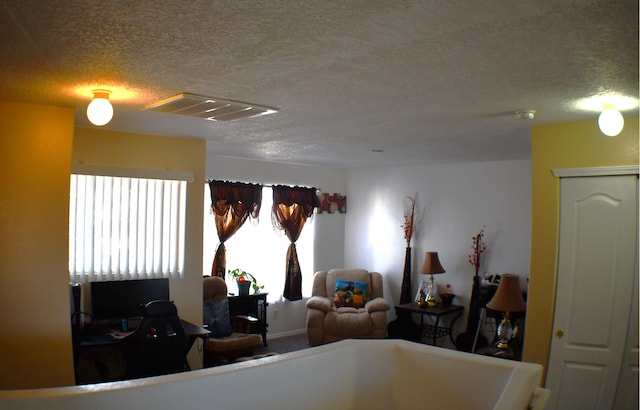 interior space featuring visible vents and a textured ceiling