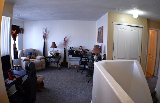 bedroom with carpet, a closet, and a textured ceiling