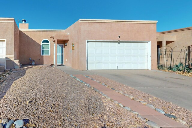 pueblo-style home with a garage