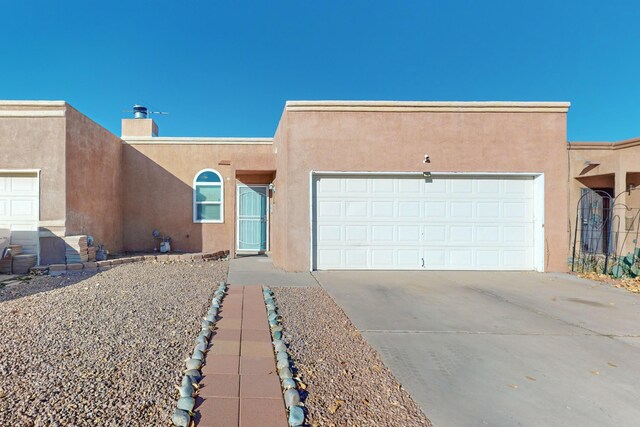 pueblo-style home with a garage