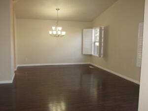 spare room featuring a chandelier and dark hardwood / wood-style flooring