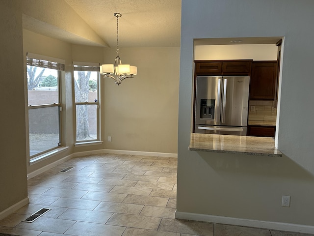 kitchen featuring visible vents, lofted ceiling, stainless steel fridge with ice dispenser, dark brown cabinetry, and a notable chandelier