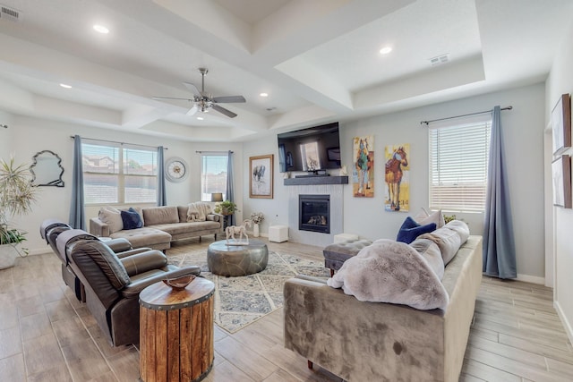 living room featuring ceiling fan and beamed ceiling