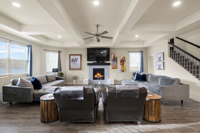 living room featuring ceiling fan and a tray ceiling