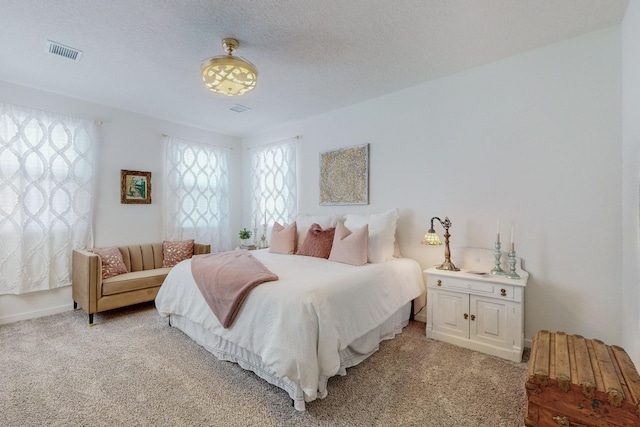 carpeted bedroom with a textured ceiling