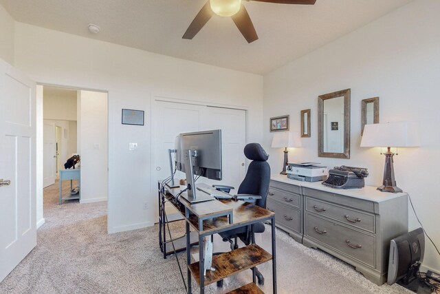 office space featuring light carpet and ceiling fan