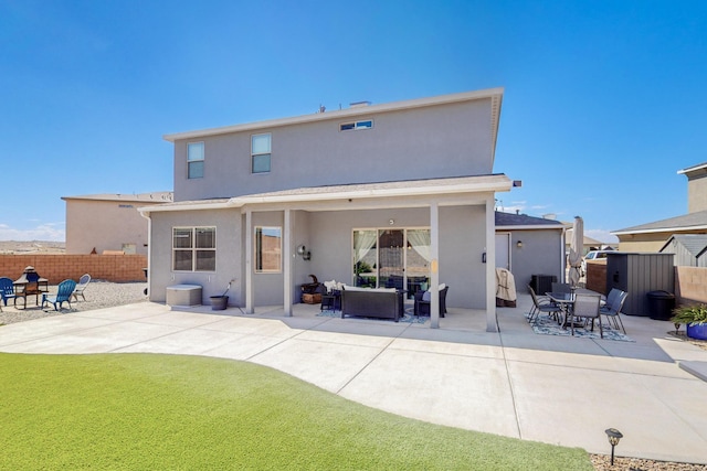 rear view of house with a yard and a patio