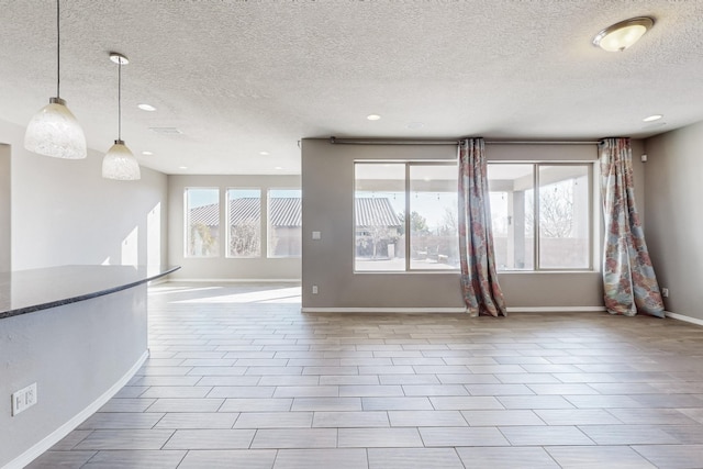 spare room with a textured ceiling