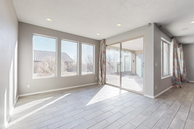 unfurnished room featuring a textured ceiling