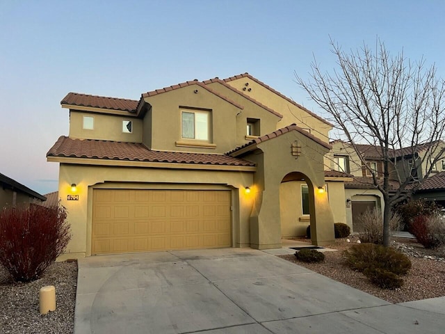 mediterranean / spanish home with a garage