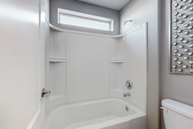 bathroom featuring toilet and tub / shower combination