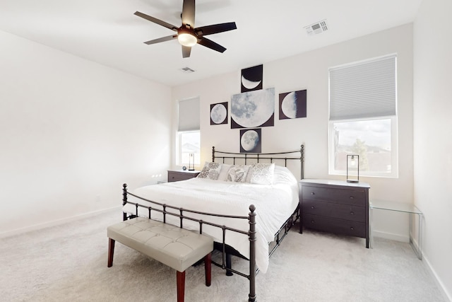 bedroom featuring light colored carpet and ceiling fan