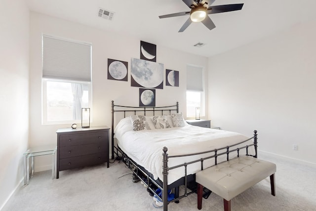 carpeted bedroom with ceiling fan and multiple windows