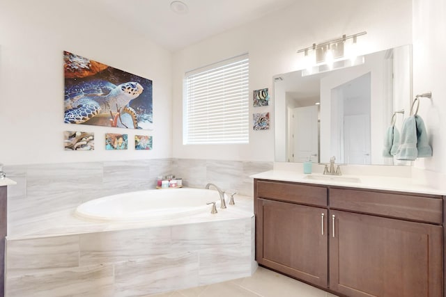 bathroom featuring vanity, tiled bath, and tile patterned floors