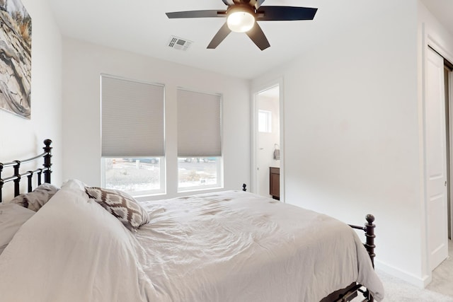 carpeted bedroom featuring ensuite bathroom and ceiling fan