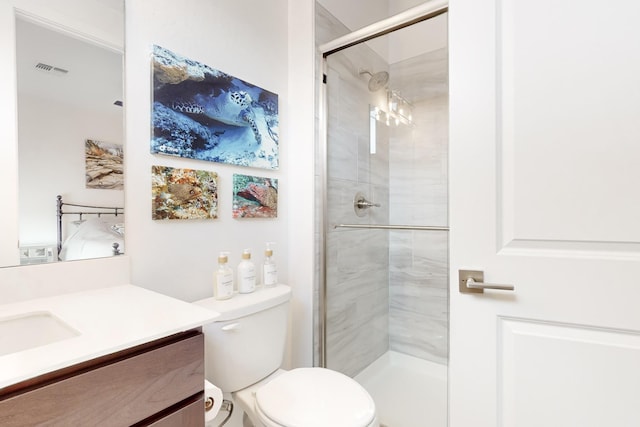 bathroom featuring vanity, toilet, and an enclosed shower