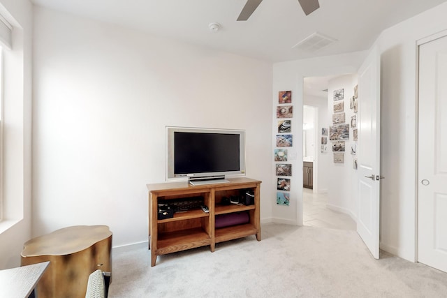 living room featuring light carpet and ceiling fan