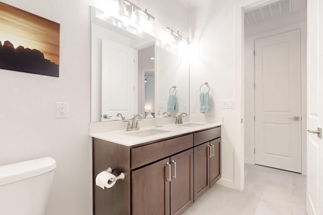 bathroom with vanity, tile patterned floors, and toilet