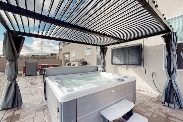 view of patio / terrace with a hot tub