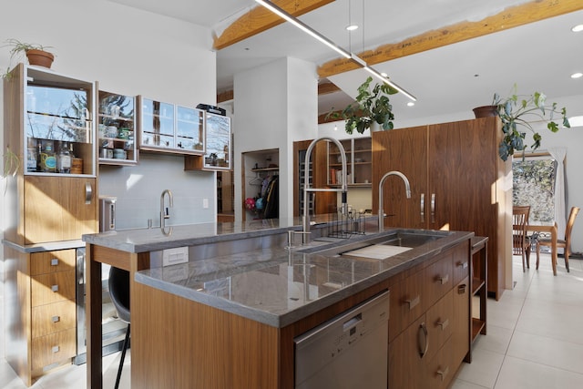 kitchen featuring tasteful backsplash, a breakfast bar, sink, white dishwasher, and light tile patterned floors