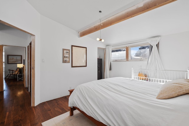 bedroom featuring dark hardwood / wood-style flooring, lofted ceiling with beams, and an inviting chandelier