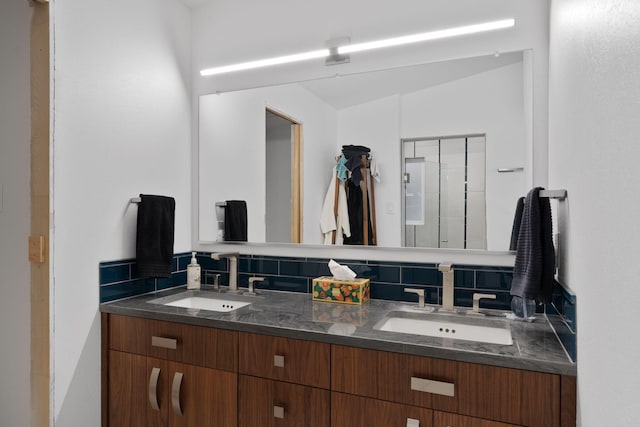 bathroom with lofted ceiling and vanity