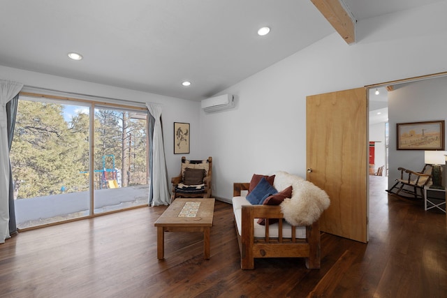 sitting room featuring lofted ceiling with beams, dark hardwood / wood-style floors, and a wall mounted air conditioner