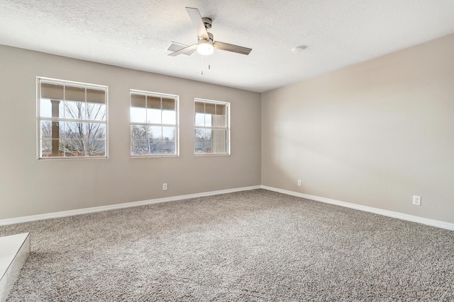 carpeted empty room with ceiling fan and a textured ceiling