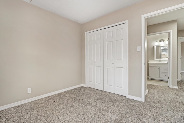 unfurnished bedroom with light colored carpet and a closet