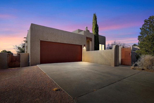 pueblo revival-style home with a garage