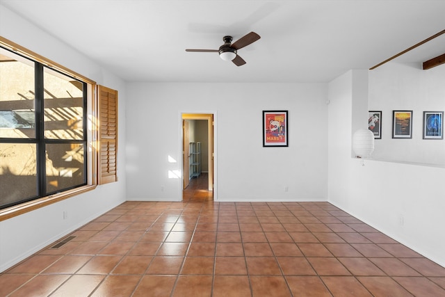 spare room featuring ceiling fan and tile patterned floors