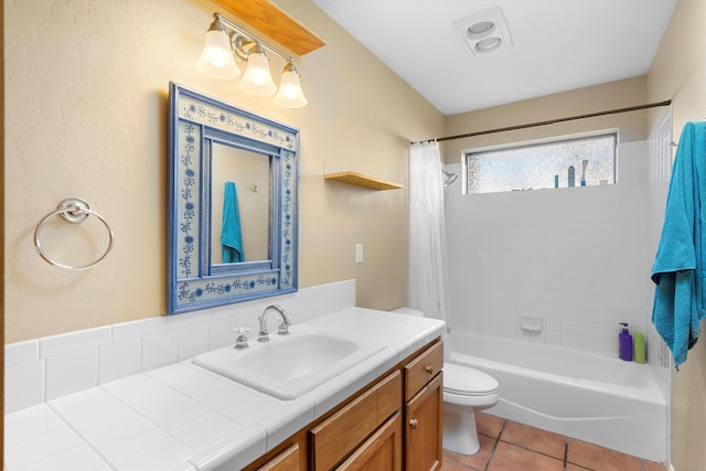 full bathroom featuring toilet, tile patterned floors, vanity, and shower / bath combo