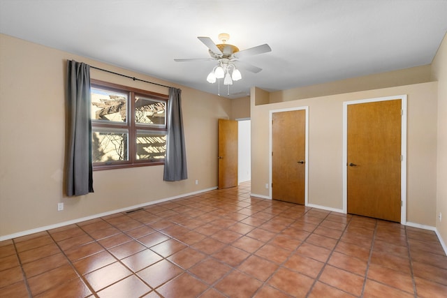 unfurnished bedroom featuring ceiling fan and tile patterned flooring