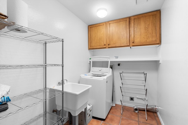 clothes washing area with cabinets, light tile patterned floors, washer / clothes dryer, and sink