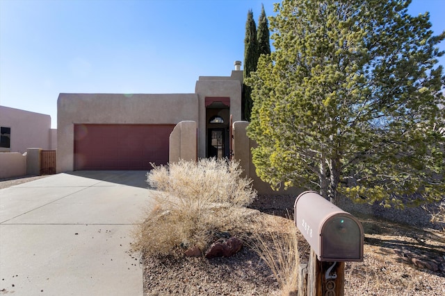 pueblo revival-style home with a garage